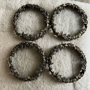 Poinsettia and berries antique gold colored candle rings, 4” in diameter.